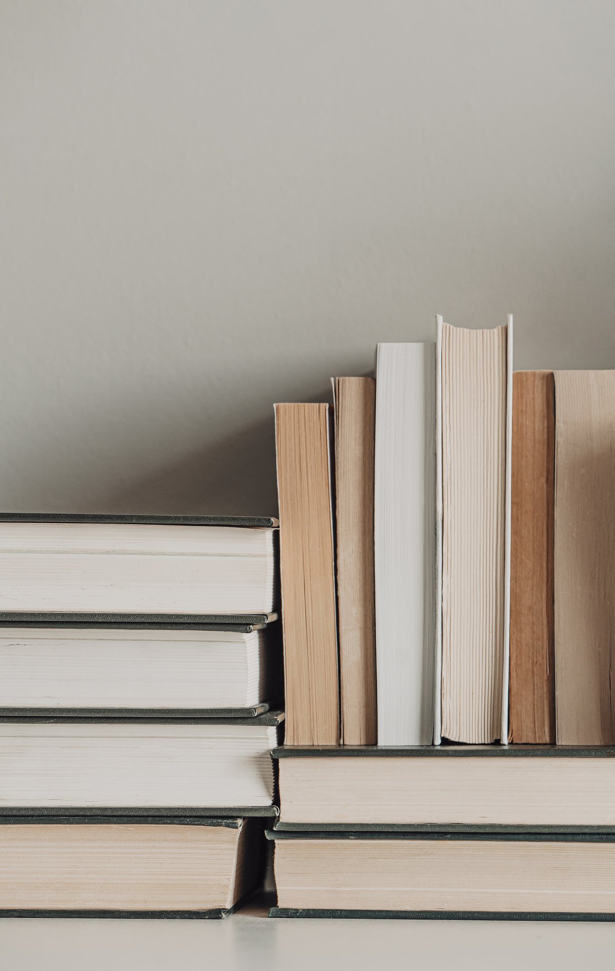 Light brown and neutral aesthetic book stack, background with copy space